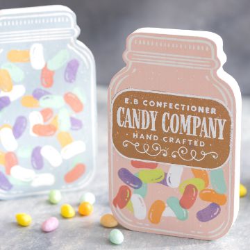 Show details for Jelly Beans Two colorful candy jars filled with jelly beans are displayed. The jar in the foreground is pastel pink with the label "Chalk Couture Transfer" while the jar in the background is light blue. Several jelly beans are scattered around.