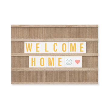 Show details for Bumblebee Paste Single A wooden sign with slats displaying the message "WELCOME HOME" in yellow letters. A blue smiling face emoji and a red heart emoji follow the text, all created using Chalk Couture paste.