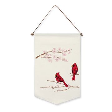 Show details for Candy Apple Ink Single A Chalk Couture ink features two red cardinals perched on branches against a cream background. Above them, cherry blossoms in pink bloom delicately. The tapestry hangs from a brown leather cord.