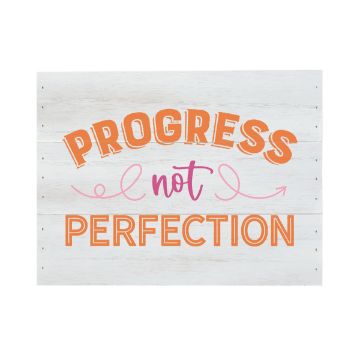 Show details for Orange Peel Paste Single A Chalk Couture paste with a whitewashed finish displays the phrase "Progress not Perfection" in large, colorful text. "Progress" and "Perfection" are written in orange, while "not" is in pink with decorative swirls. The paste conveys a motivational message.
