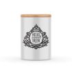 A cylindrical white container with a wooden lid features an intricate black decorative design surrounding the text "Chalk Couture paste" in the center. The overall aesthetic is vintage and charming. The background is plain white.