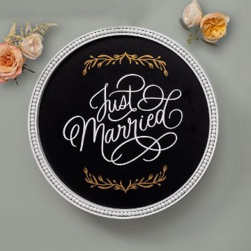 Show details for Just Married A Chalk Couture transfer with a white beaded border displays the words "Just Married" in elegant white and gold script. Gold floral accents embellish the top and bottom of the transfer. Two peach and cream roses are positioned around the transfer on a light gray background.