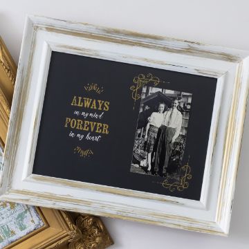 Show details for Forever in My Heart A framed photo with a black background features an elderly couple standing together. The text next to the photo says, "Always on my mind, forever in my heart" in gold lettering. The frame is white with distressed details, adding a vintage touch. This beautiful design is created using the Chalk Couture transfer.
