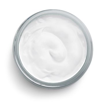 Show details for Bright White Ink A top view of a clear glass container filled with smooth, white Chalk Couture ink. The ink has a slightly glossy texture with gentle swirls on its surface, suggesting it has been scooped or spread. The container's round rim is clearly visible against a plain white background.