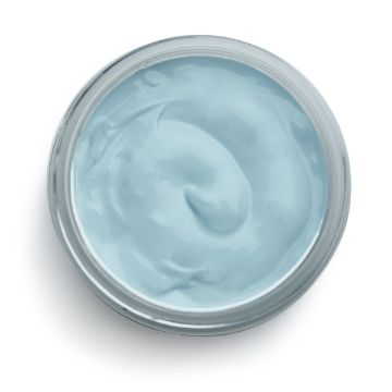 Show details for Ocean Mist Paste A top-down view of a small, open jar filled with smooth, light blue Chalk Couture paste. The texture looks creamy and is evenly spread within the jar, with some subtle swirls visible. The jar has a clear glass appearance.