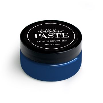 Show details for Cadet Paste A small, round container with a black lid labeled "Chalk Couture" and "paste" in white text. The lower part of the container is transparent, showing deep blue paste inside. The phrase "Washable Paste" is also visible on the label.