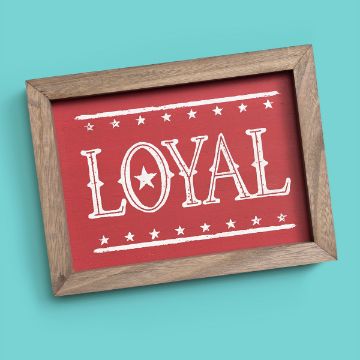 Show details for Loyal A transfer by Chalk Couture with a rustic wooden border. The interior is red with the word "LOYAL" in bold white letters, featuring a star inside the letter O. Decorative stars align above and below the word. The background is a solid turquoise color.