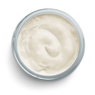 Show details for Vanilla Paste A small, open jar filled with smooth, white cream. The cream is swirled neatly inside the jar, and the jar itself is clear with a slight blue tint at the rim. The background is plain white.