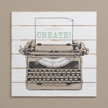 Show details for Shiplap Sign (18" x 18") An illustration of an antique typewriter on a white wooden background with a slightly worn texture. A sheet of paper in the typewriter bears the phrase "Created to Create!" in green and black lettering.