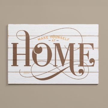 Show details for Shiplap Sign (12" x 18") A wooden sign with a white background and horizontal lines displays the phrase "Make Yourself at Home" in decorative brown lettering. The word "Home" is particularly large and ornate. The sign is mounted against a beige wall.