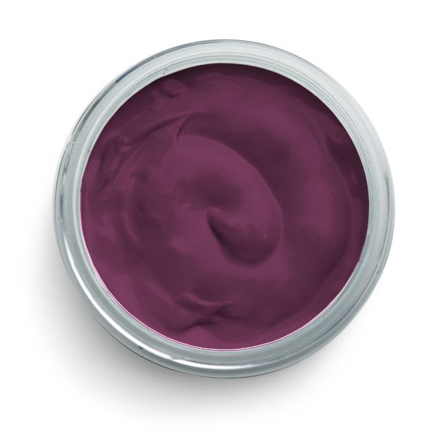 A top view of a silver tin filled with smooth, rich purple paint or cream. The surface of the contents shows a slightly swirled texture. The tin sits on a plain white background.