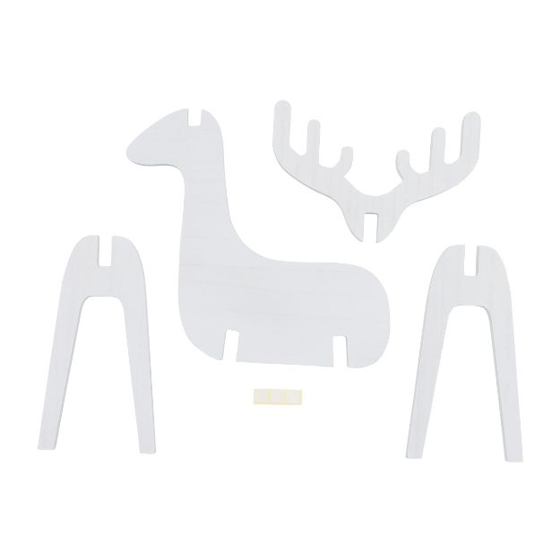 A flat pack of wooden pieces including the body, legs, and antlers of a reindeer, along with a small rectangular piece, all arranged on a white background. The pieces are designed to be assembled into a standing reindeer figure.