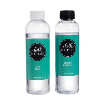 Show details for Resin & Hardener Two clear plastic bottles of Chalk Couture resin and hardener, each with a turquoise label and black lid. The bottle on the left is labeled "Resin" and the bottle on the right is labeled "Hardener." Both bottles have black circular logos with "Chalk Couture" text.