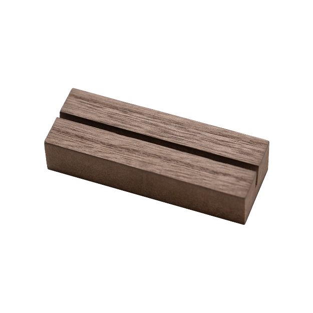 A rectangular wooden block with a single groove running lengthwise across its top surface, made of a brown wood with a natural grain pattern.