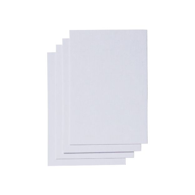 Four blank sheets of white paper are stacked slightly askew against a plain white background.