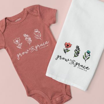 Show details for Grow In Grace A terracotta-colored baby onesie and a white cloth lay side by side. Both feature floral designs and the text "grow in grace, 2 Peter 3:18." The onesie has white flowers, while the cloth has vibrant, colored flowers.