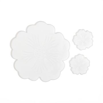 Show details for Tropical Tray & Coaster Molds A large, translucent, flower-shaped plate is accompanied by two smaller matching plates. Each plate features a radial pattern resembling flower petals. The design is delicate and minimalistic, on a plain white background.