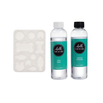 Show details for Pet Tag Mold Bundle A resin crafting kit including a silicone mold with various shapes and two bottles labeled "Chalk Couture." One bottle reads "Resin" with a white cap, and the other reads "Hardener" with a black cap.