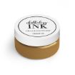 A small jar of gold-colored Chalkology Ink from Chalk Couture. The jar has a white lid with black text, reading "Chalkology Ink, Chalk Couture, Permanent Ink.