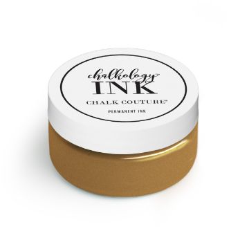 Show details for Nominee Ink A small jar of gold-colored Chalkology Ink from Chalk Couture. The jar has a white lid with black text, reading "Chalkology Ink, Chalk Couture, Permanent Ink.