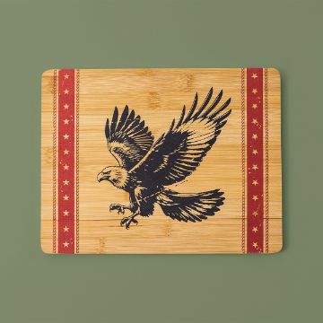 Show details for God Bless America A wooden cutting board with an engraved image of an eagle in mid-flight. The board features red borders with a pattern of stars on both sides, set against a plain green background.