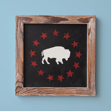 Show details for Schoolhouse Frame (9" x 9") Framed art featuring a white silhouette of a bison centered on a black background, encircled by twelve red stars. The frame is rustic, made of weathered wood, and the background is a light blue color.