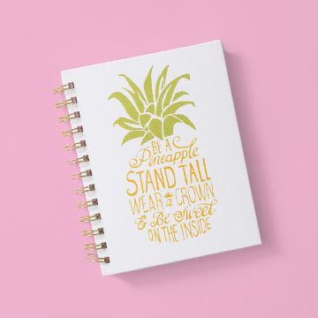 Show details for Be A Pineapple A white spiral notebook with a gold and green pineapple illustration and the words "Be a Pineapple. Stand tall, wear a crown & be sweet on the inside" on a pink background.