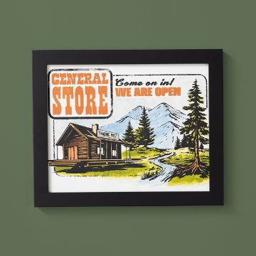 Show details for General Store Framed illustration of a rustic trading post cabin labeled "General Store" with mountains, trees, and a winding path. Text reads, "Come on in! We are open." Artwork set against a green wall.