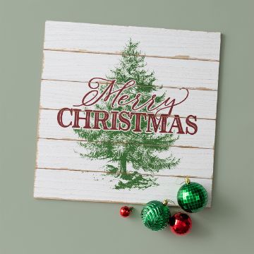 Show details for Merry Christmas Tree A white wooden sign with a green Christmas tree and red text that reads "Merry Christmas," with three festive ornaments—two green and one red—placed at the bottom right corner.
