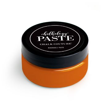 Show details for Marmalade Paste (En Vogue) A small round container with a black lid labeled "Chalkology Paste, Chalk Couture, Washable Paste," filled with bright orange paste. The container is set against a white background.