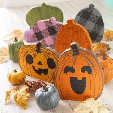 Show details for Pumpkin Chubbies Wooden pumpkins painted with cheerful and jack-o’-lantern faces are displayed among painted mini pumpkins and autumn leaves on a light wooden surface, creating a festive fall and Halloween scene.