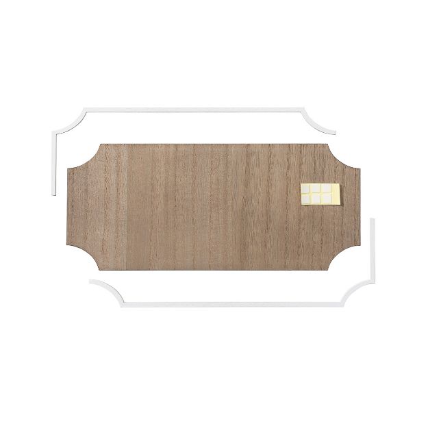 A rectangular wooden board with curved ends sits on a white background. Four white L-shaped brackets and six small cream-colored tiles are arranged on the board’s upper right corner.