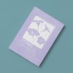 A lavender notebook with a white illustration of morning glory flowers and the text "September Morning Glory" on the cover, placed on a teal surface.