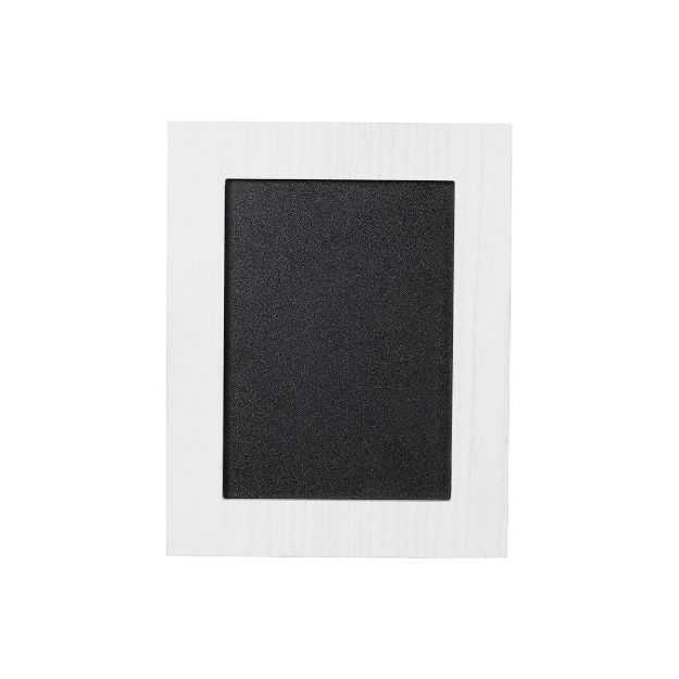 A blank black chalkboard with a white wooden frame, centered on a plain white background.
