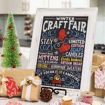Show details for Winter Craft Fair A festive kitchen scene with a decorated mini Christmas tree, wrapped gifts, and a framed chalkboard sign advertising a winter craft fair with cozy items, soaps, candles, baked bread, and cocoa by the campfire.