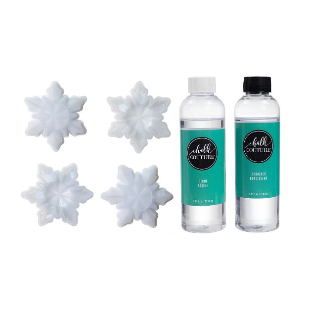 Four white, plastic snowflake molds are arranged next to two bottles of Chalk Couture resin, labeled "Resin” and “Hardener." All items are displayed against a white background.