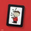 A framed illustration of a cartoon boy smiling and holding a small, sparse Christmas tree, set against a red background.