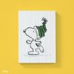 A drawing of Snoopy wearing a green and black striped winter hat with a pom-pom, standing on one foot against a plain white background, with a yellow backdrop behind the artwork.