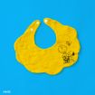 A yellow scalloped baby bib features a black line drawing of cartoon characters Charlie Brown, Snoopy, and Woodstock, set against a bright blue background.