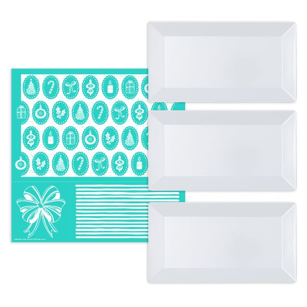 A turquoise placemat with white holiday-themed icons and three rectangular white plates placed to the right of it. The placemat features ornaments, gifts, a bow, and striped patterns.