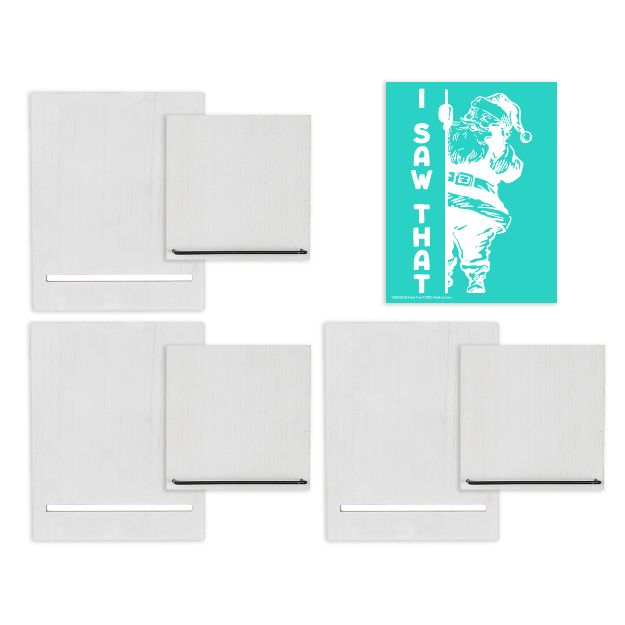 Four white wooden boards with horizontal metal bars are arranged in a grid, and a turquoise card with an illustration of Santa Claus and the text "I SAW THAT" is placed in the top right corner.