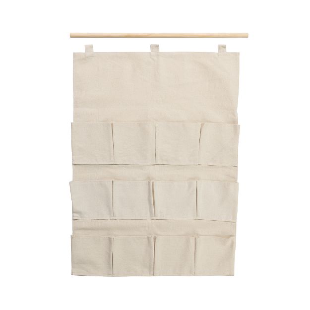A beige fabric hanging organizer with three rows of multiple pockets, attached to a wooden rod by loops at the top. The organizer is empty and displayed against a white background.