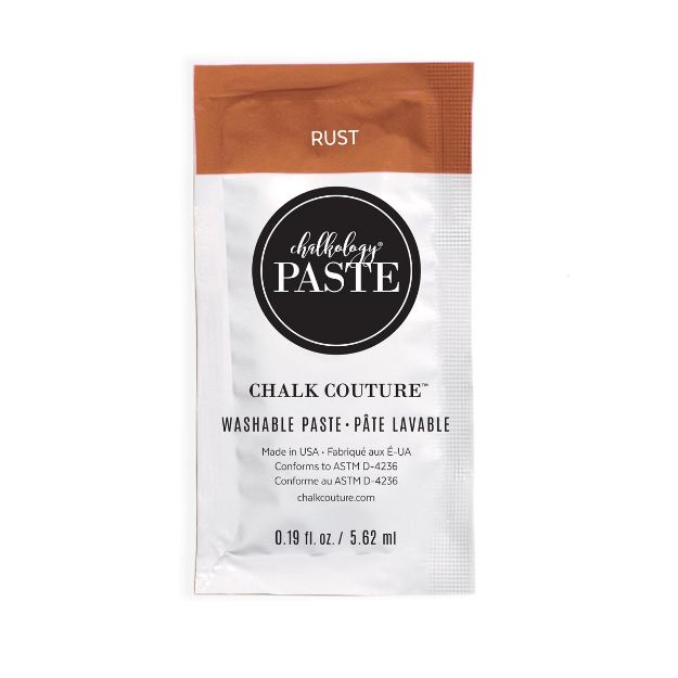 A small packet of Chalk Couture washable paste in the color "Rust," featuring a white label with black and brown accents, product details, and a round logo at the center. The packet contains 0.19 fl. oz. (5.62 ml).
