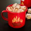 A red mug with a campfire illustration holds hot chocolate topped with toasted marshmallows.