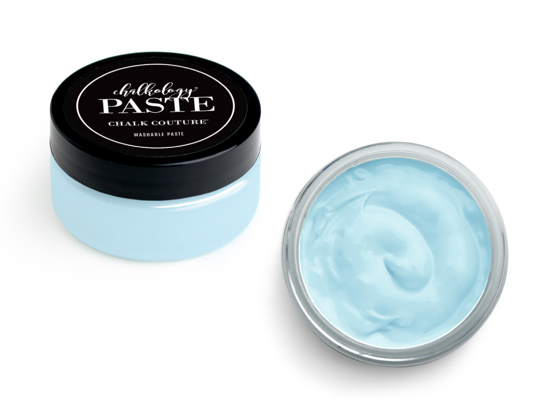 A small round jar with a black lid labeled "Chalkology Paste Chalk Couture Washable Paste" is shown with the lid off, revealing smooth, light blue paste inside.
