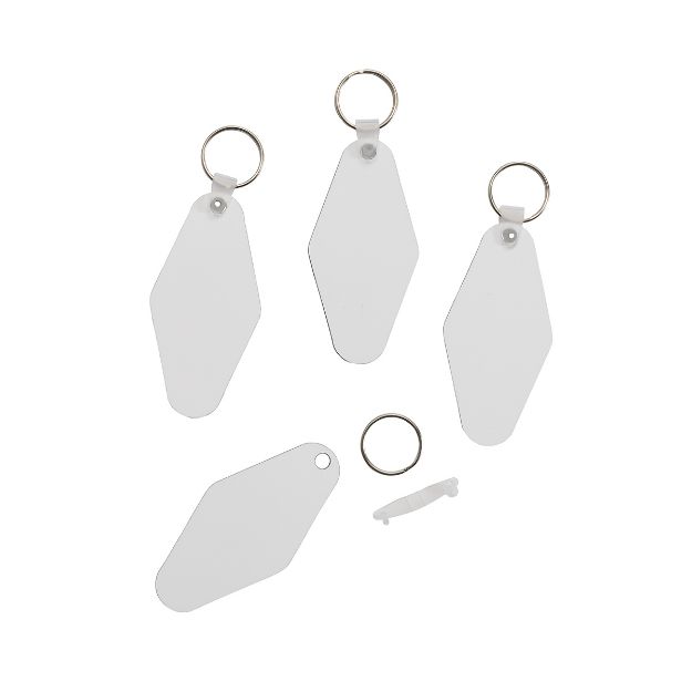Four blank white key tags with metal rings are displayed on a white background. One ring and a small white plastic piece are detached and lay near the tags.