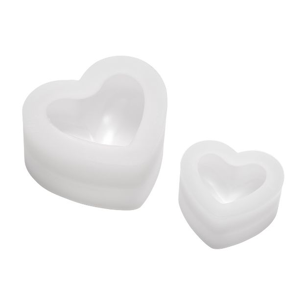 Two white, heart-shaped silicone molds of different sizes are shown on a plain white background. The molds have smooth edges and are nested, each with a hollow center.