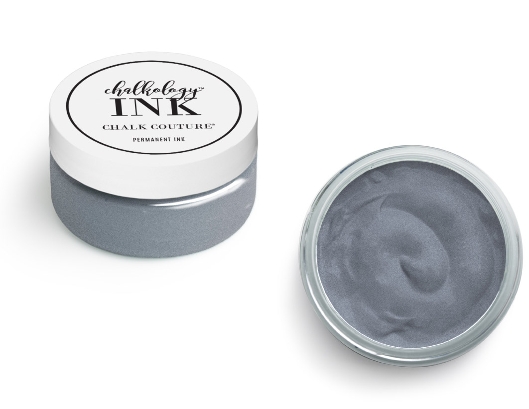 A small round container of Chalkology Ink by Chalk Couture with gray permanent ink inside, shown with the lid on the left and an open view of the smooth ink on the right.