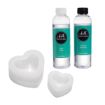 Two bottles labeled "Chalk Couture" resin and hardener stand upright beside two white, heart-shaped silicone molds of different sizes on a plain white background.