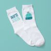 A pair of white socks on a teal background; one sock features the text "warm & cozy" in blue and teal, and the other sock has a blue and teal knit winter hat graphic.